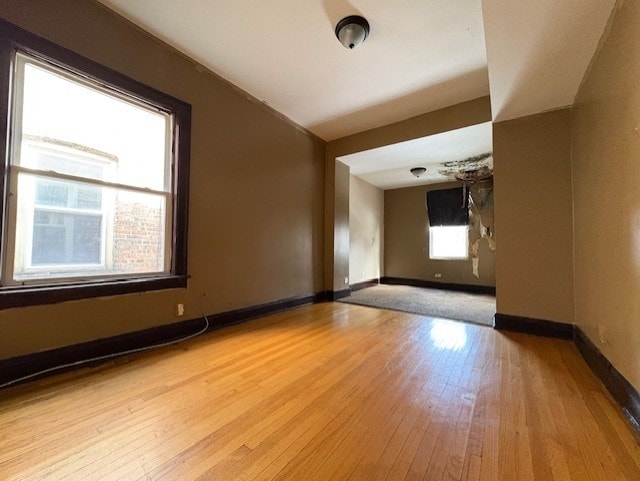 spare room with hardwood / wood-style floors and baseboards