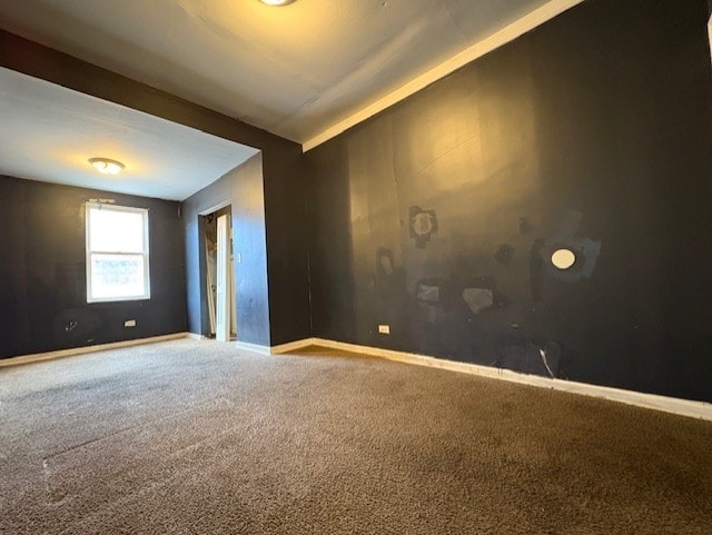 carpeted empty room with baseboards