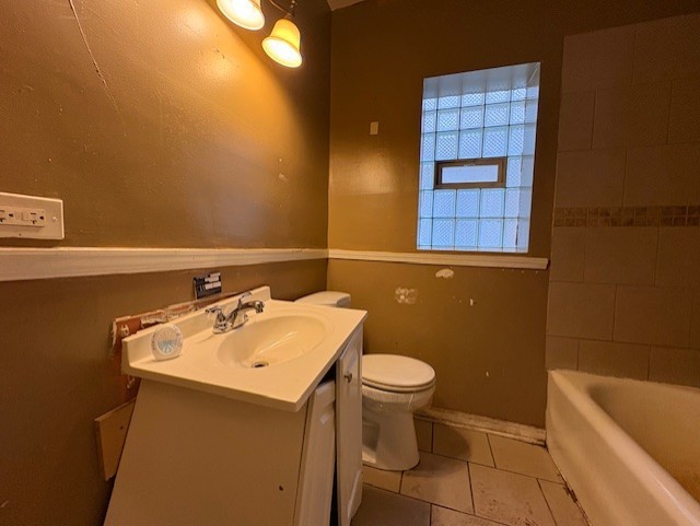 full bathroom featuring a shower, vanity, toilet, tile patterned floors, and a bathtub