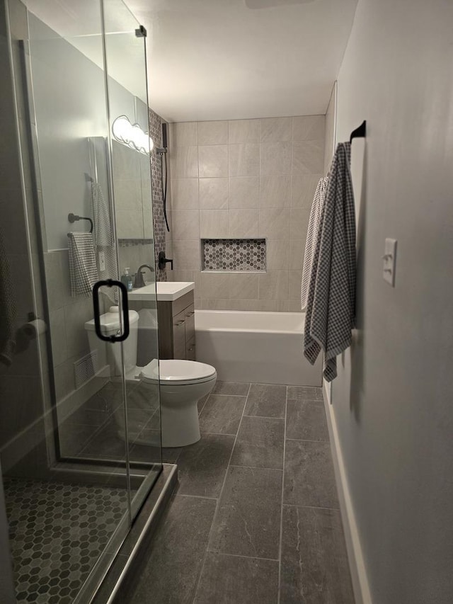 bathroom featuring a stall shower, toilet, a bath, and vanity