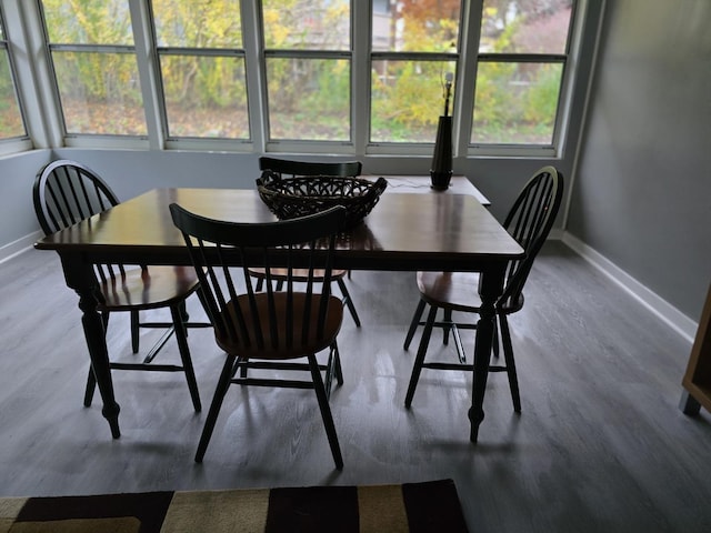 dining area with a wealth of natural light, wood finished floors, and baseboards
