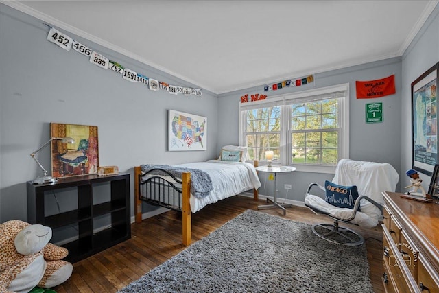 bedroom featuring baseboards, ornamental molding, and wood finished floors