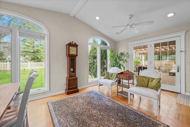 living area featuring wood finished floors, baseboards, ceiling fan, vaulted ceiling with beams, and french doors