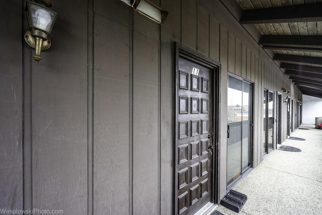 doorway to property featuring board and batten siding