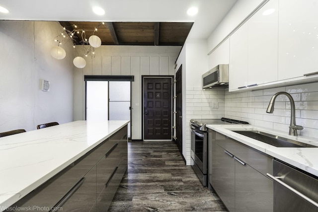 kitchen with stainless steel appliances, modern cabinets, gray cabinets, and a sink