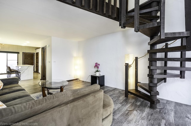 living area featuring wood finished floors and stairs