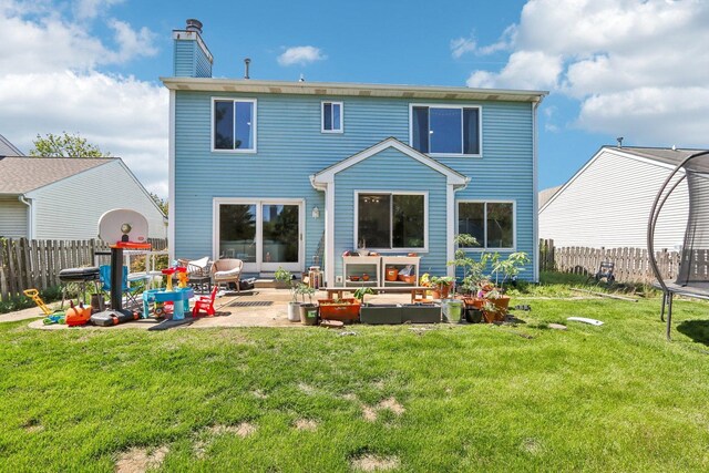 1462 Belle Haven Dr, Grayslake, IL 60030 - rear view of property featuring an outdoor living space, a trampoline, a patio, and a chimney