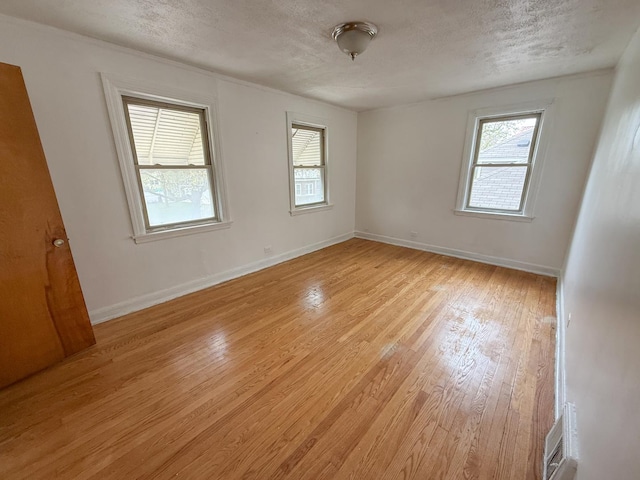 1714 W Beverly Glen Pkwy, Chicago, IL 60643 - spare room featuring a textured ceiling, baseboards, visible vents, and light wood-type flooring