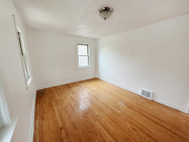 1714 W Beverly Glen Pkwy, Chicago, IL 60643 - spare room featuring baseboards, visible vents, and light wood-style floors