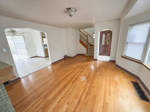 1714 W Beverly Glen Pkwy, Chicago, IL 60643 - entrance foyer featuring visible vents, baseboards, stairway, arched walkways, and light wood-style flooring
