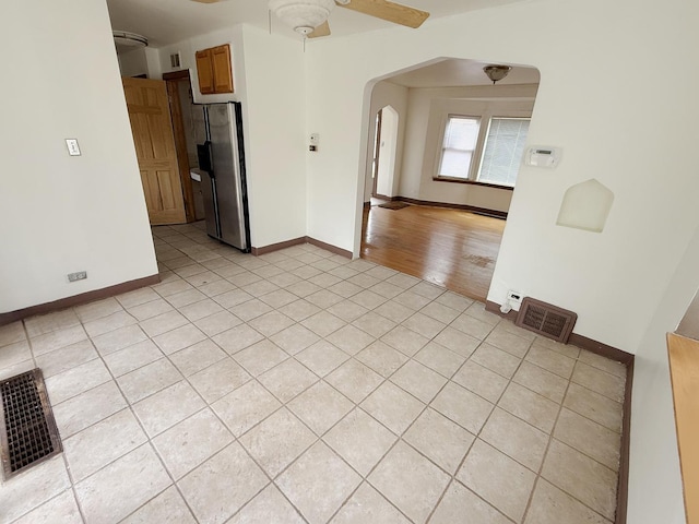 1714 W Beverly Glen Pkwy, Chicago, IL 60643 - unfurnished room featuring visible vents, arched walkways, ceiling fan, and light tile patterned floors