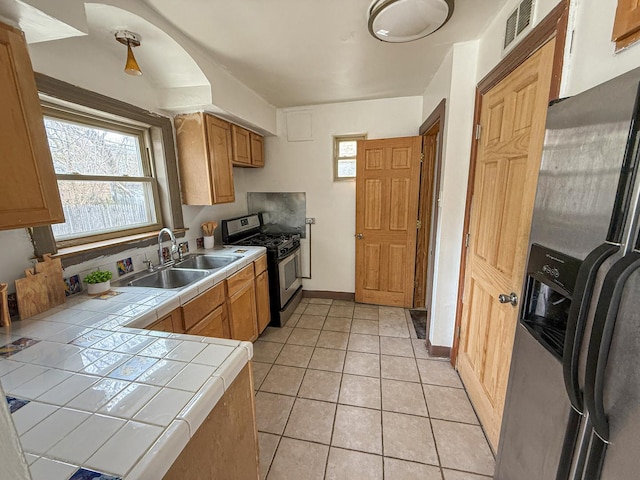 1714 W Beverly Glen Pkwy, Chicago, IL 60643 - kitchen with a sink, tile countertops, stainless steel appliances, light tile patterned floors, and visible vents