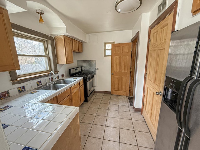 1714 W Beverly Glen Pkwy, Chicago, IL 60643 - kitchen with visible vents, tile counters, a sink, appliances with stainless steel finishes, and light tile patterned floors