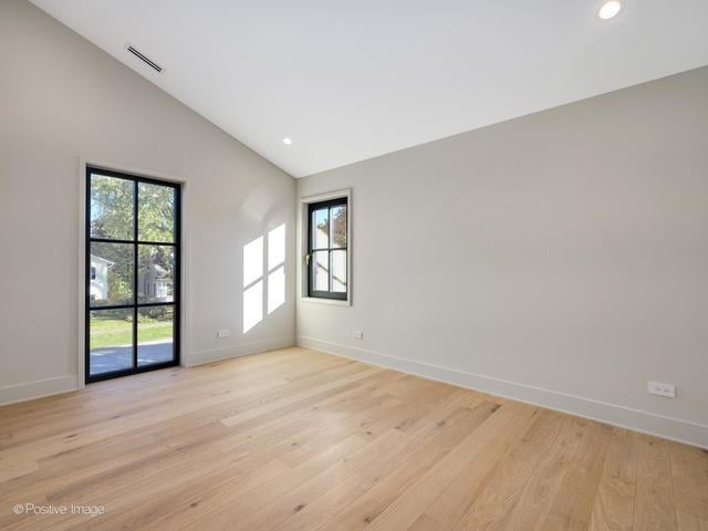 unfurnished room featuring visible vents, baseboards, light wood-type flooring, recessed lighting, and vaulted ceiling
