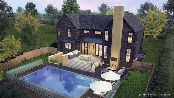 back of property at dusk with a standing seam roof, metal roof, an outdoor living space, a chimney, and fence