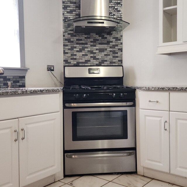 11258 S Normandy Ave, Worth, IL 60482 - kitchen featuring wall chimney range hood, decorative backsplash, stainless steel gas range, glass insert cabinets, and white cabinetry