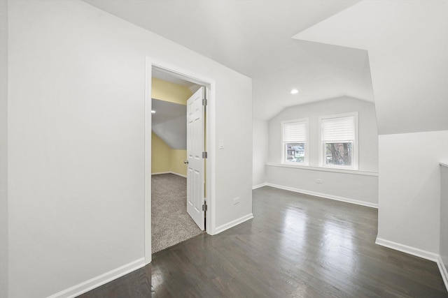 additional living space with recessed lighting, baseboards, dark wood-style floors, and lofted ceiling