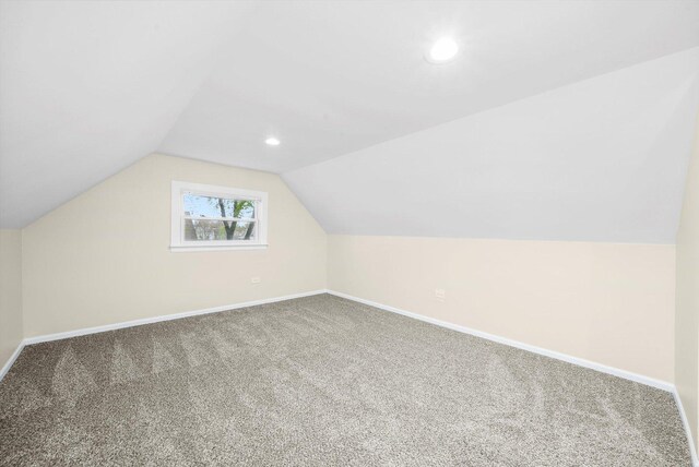 additional living space with carpet floors, recessed lighting, baseboards, and vaulted ceiling