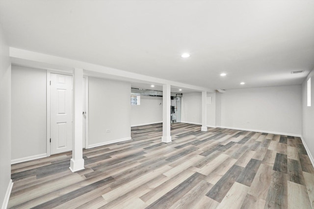 basement featuring recessed lighting, baseboards, and wood finished floors