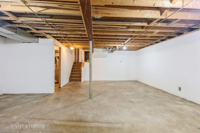 unfinished basement featuring stairway