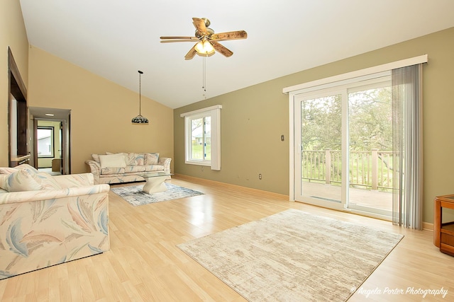 living room with ceiling fan, wood finished floors, and high vaulted ceiling