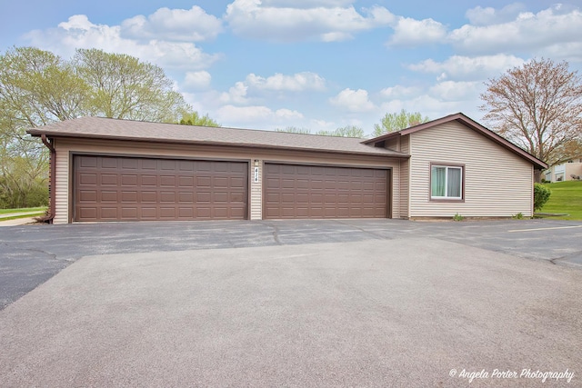 garage featuring aphalt driveway