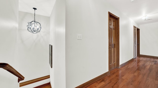 7022 W 64th St, Chicago, IL 60638 - hall featuring baseboards, visible vents, a notable chandelier, and wood-type flooring