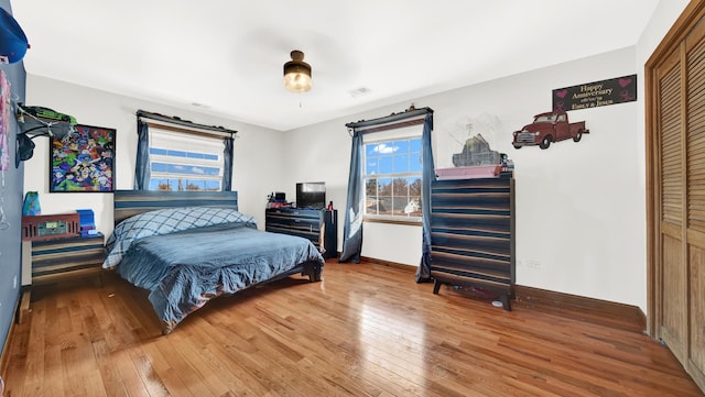 7022 W 64th St, Chicago, IL 60638 - bedroom featuring baseboards, visible vents, multiple windows, and wood-type flooring