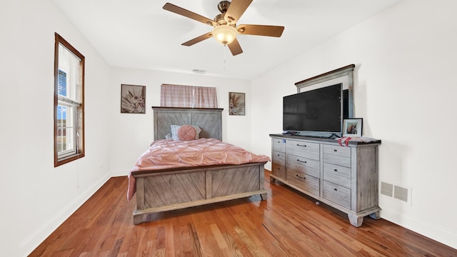 7022 W 64th St, Chicago, IL 60638 - bedroom featuring wood finished floors, a ceiling fan, visible vents, and baseboards