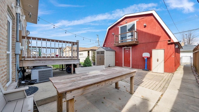 7022 W 64th St, Chicago, IL 60638 - view of patio with an outbuilding, a storage unit, and central AC