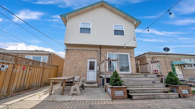 7022 W 64th St, Chicago, IL 60638 - rear view of property featuring fence, a patio area, and brick siding