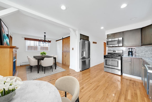7022 W 64th St, Chicago, IL 60638 - kitchen with a baseboard heating unit, decorative backsplash, stainless steel appliances, a notable chandelier, and light wood-type flooring