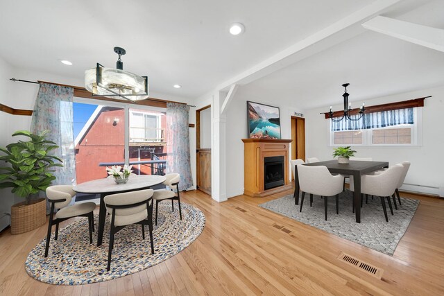 7022 W 64th St, Chicago, IL 60638 - dining room with light wood-style flooring, visible vents, a healthy amount of sunlight, and a notable chandelier