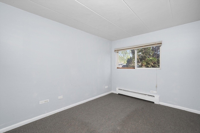 empty room with baseboards, a baseboard heating unit, and dark colored carpet