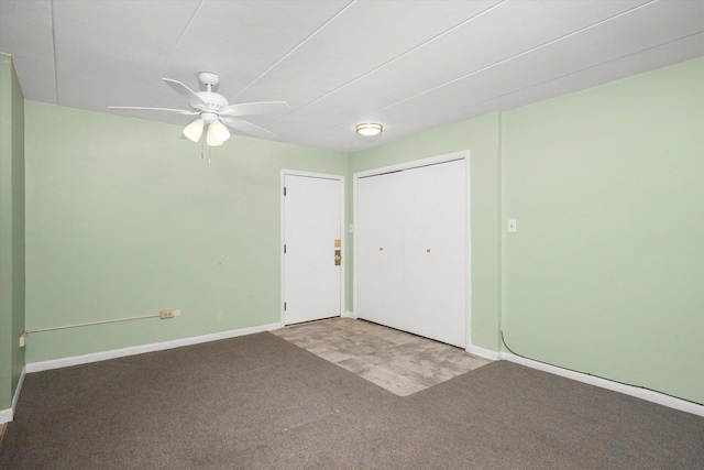 spare room with baseboards, ceiling fan, and carpet flooring