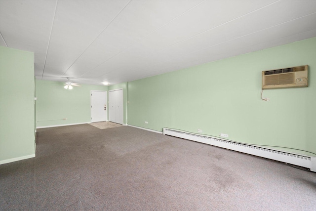 empty room with carpet floors, a baseboard radiator, baseboards, and a wall mounted AC