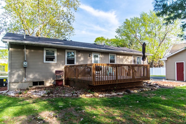 rear view of house featuring a lawn, a deck, and cooling unit