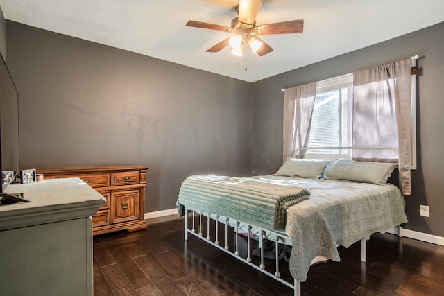 bedroom with dark wood-style flooring, baseboards, and ceiling fan