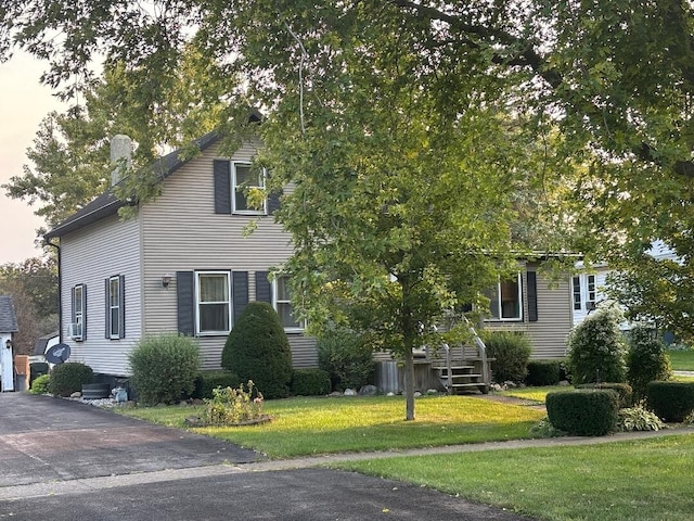 obstructed view of property with a chimney and a front yard