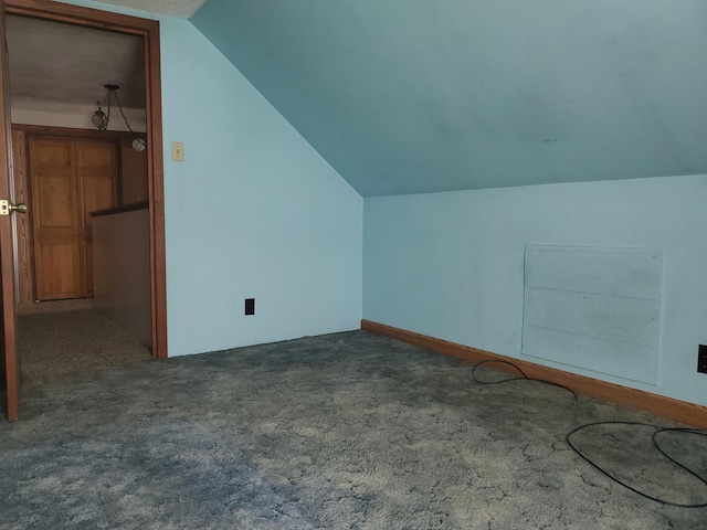 additional living space with carpet flooring and vaulted ceiling