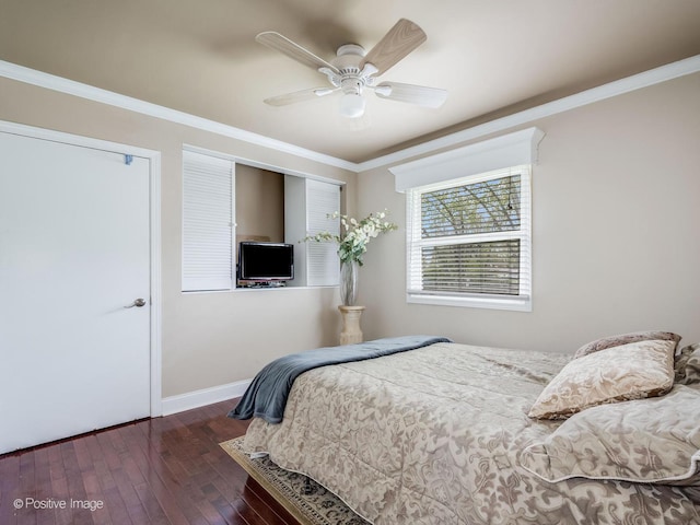 bedroom featuring wood-type flooring, a ceiling fan, baseboards, and ornamental molding