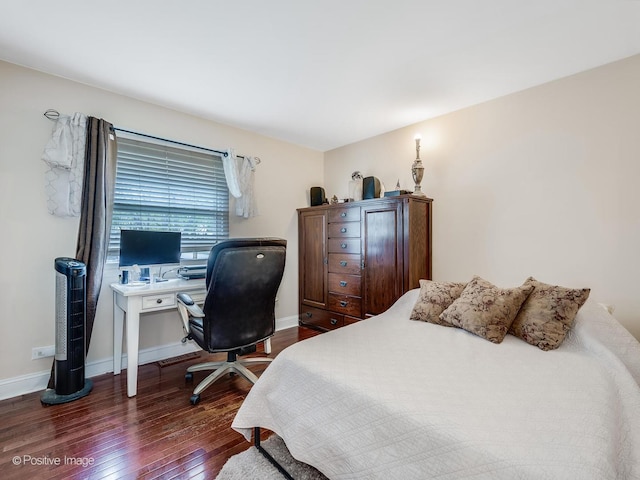 bedroom with baseboards and dark wood finished floors