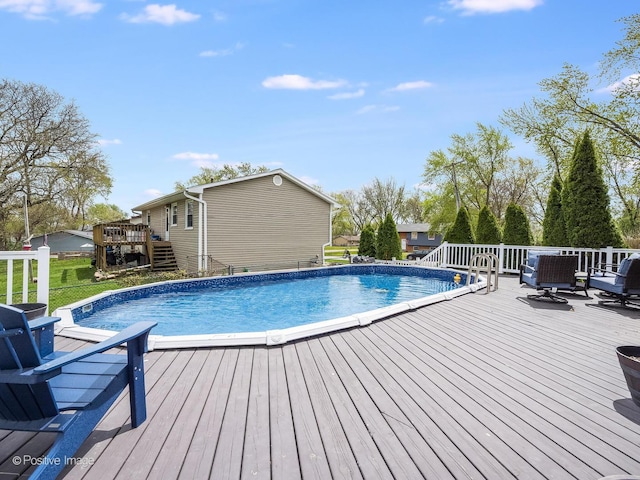 outdoor pool featuring stairs and a deck