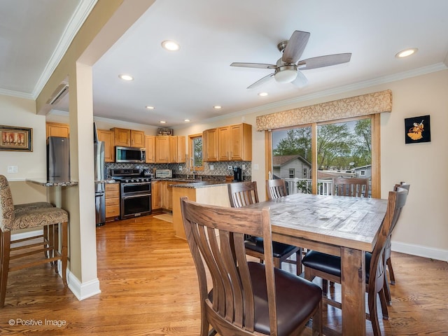 dining area with light wood-style floors, recessed lighting, ceiling fan, and ornamental molding