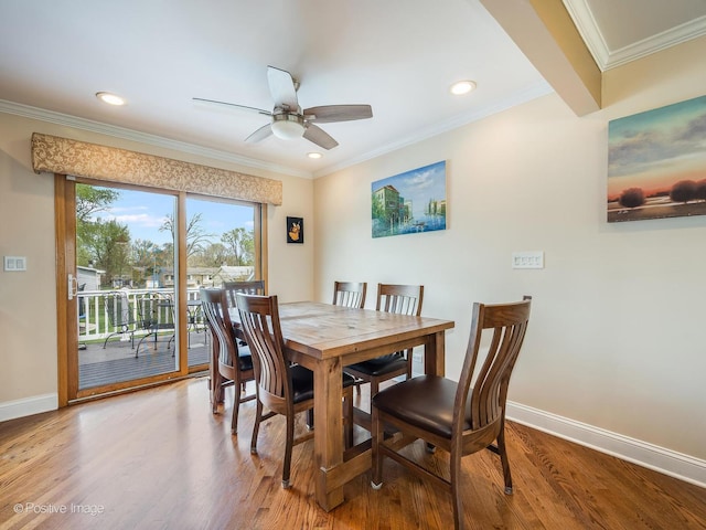 dining room with crown molding, baseboards, ceiling fan, and wood finished floors