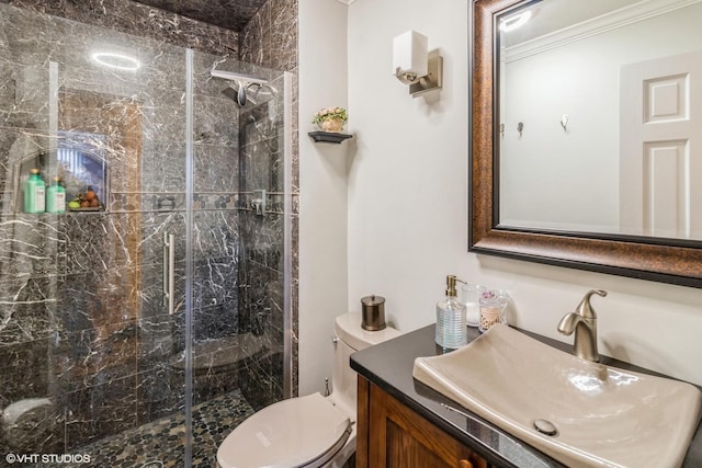 bathroom with crown molding, a marble finish shower, vanity, and toilet