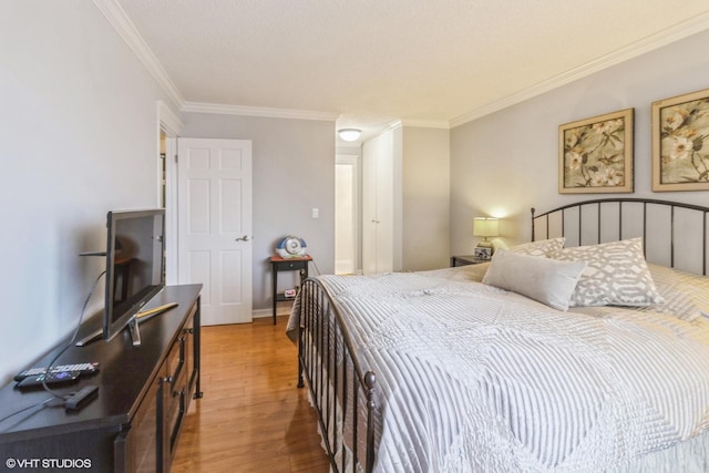 bedroom featuring ornamental molding and light wood-style flooring