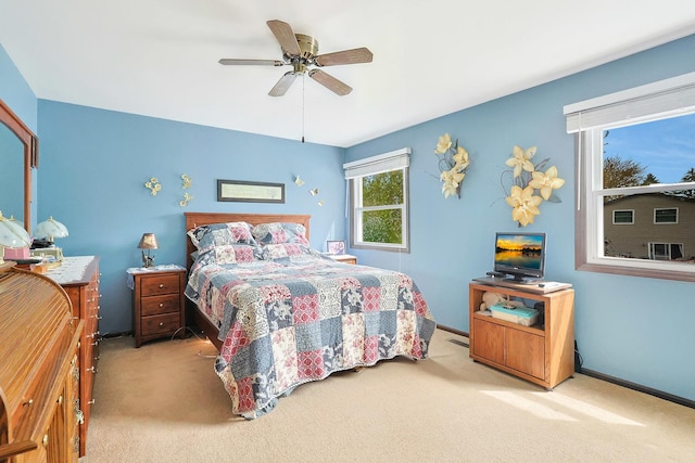 carpeted bedroom featuring ceiling fan and baseboards