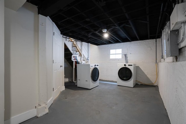 basement featuring stairway and washing machine and clothes dryer