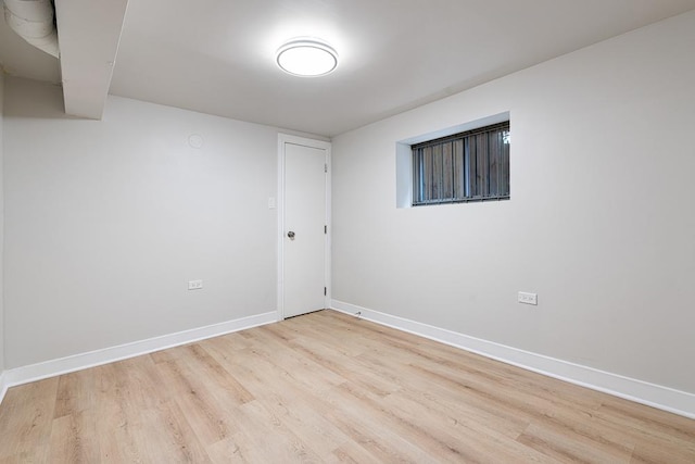 unfurnished room featuring baseboards and wood finished floors